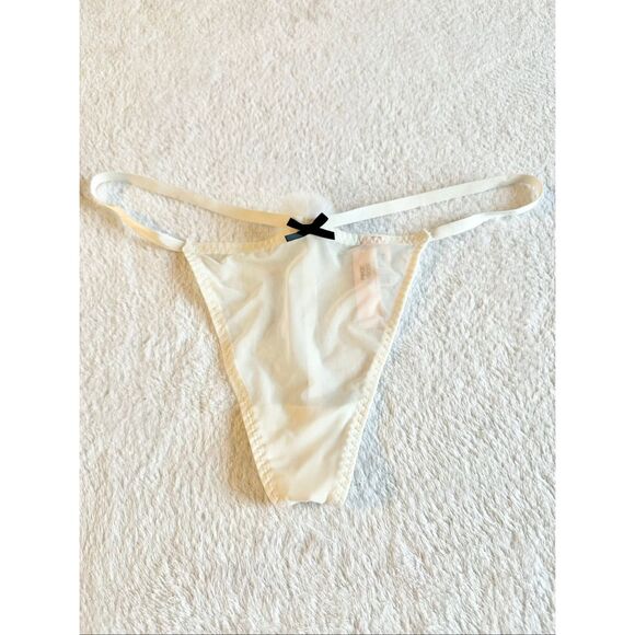 White sheer Victoria’s Secret thong new with tags with black bow detail and pom- - Picture 1 of 6